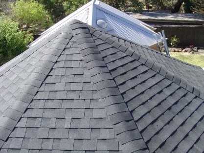 A hipped rooftop showing asphalt shingles