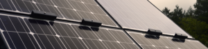 Four snow guards attached to a solar panel array